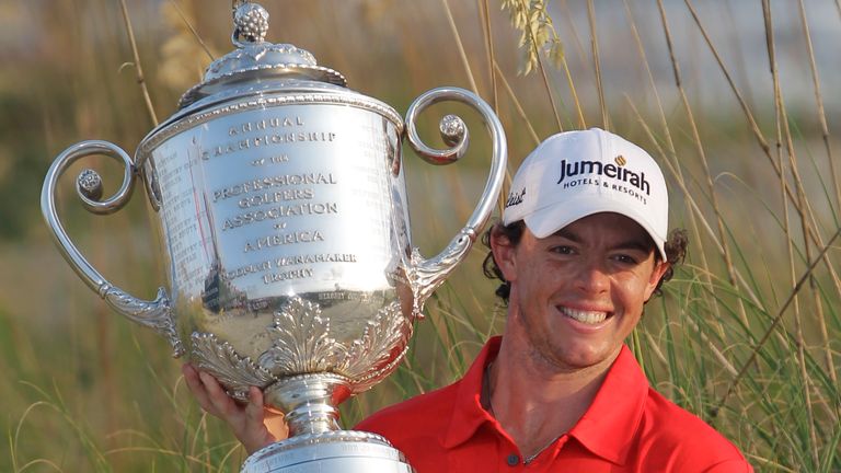 Rory McIlroy from Northern Ireland is for photographers with the championship trophy after he last round of PGA Championship Golf Tournament at Ocean Course of Kiawah Island Golf Resort on Kiawah Island, SC, Sunday 12 August 2012. (AP Photo/John Raoux)   