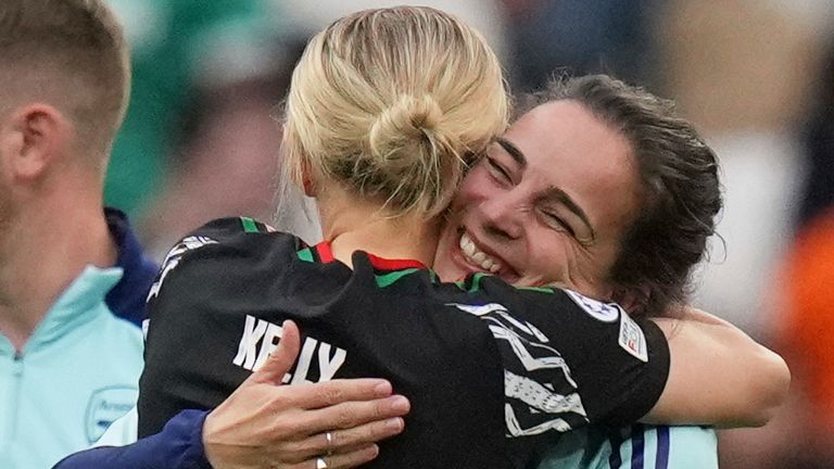 Arsenal's Chloe Kelly and Arsenal -Trainer Renee Slegers hugs each other at the end of Women's Champions League osifinal, second leg, football match between Olympique Lyonnais and Arsenal at the Decines Olympics, outside Lyon, France, Sunday April 27, 2025. (AP Photo/Thibault Camus)